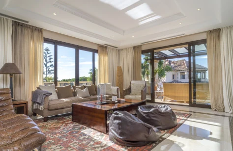 Living room with marble floors and wide sliding doors to the terrace