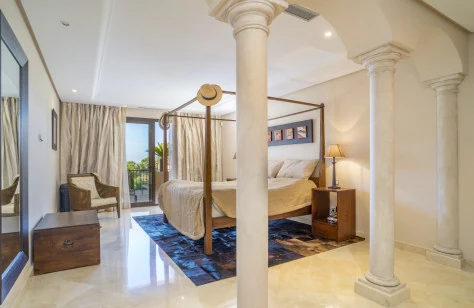 Master suite with classical columns and a four-poster bed
